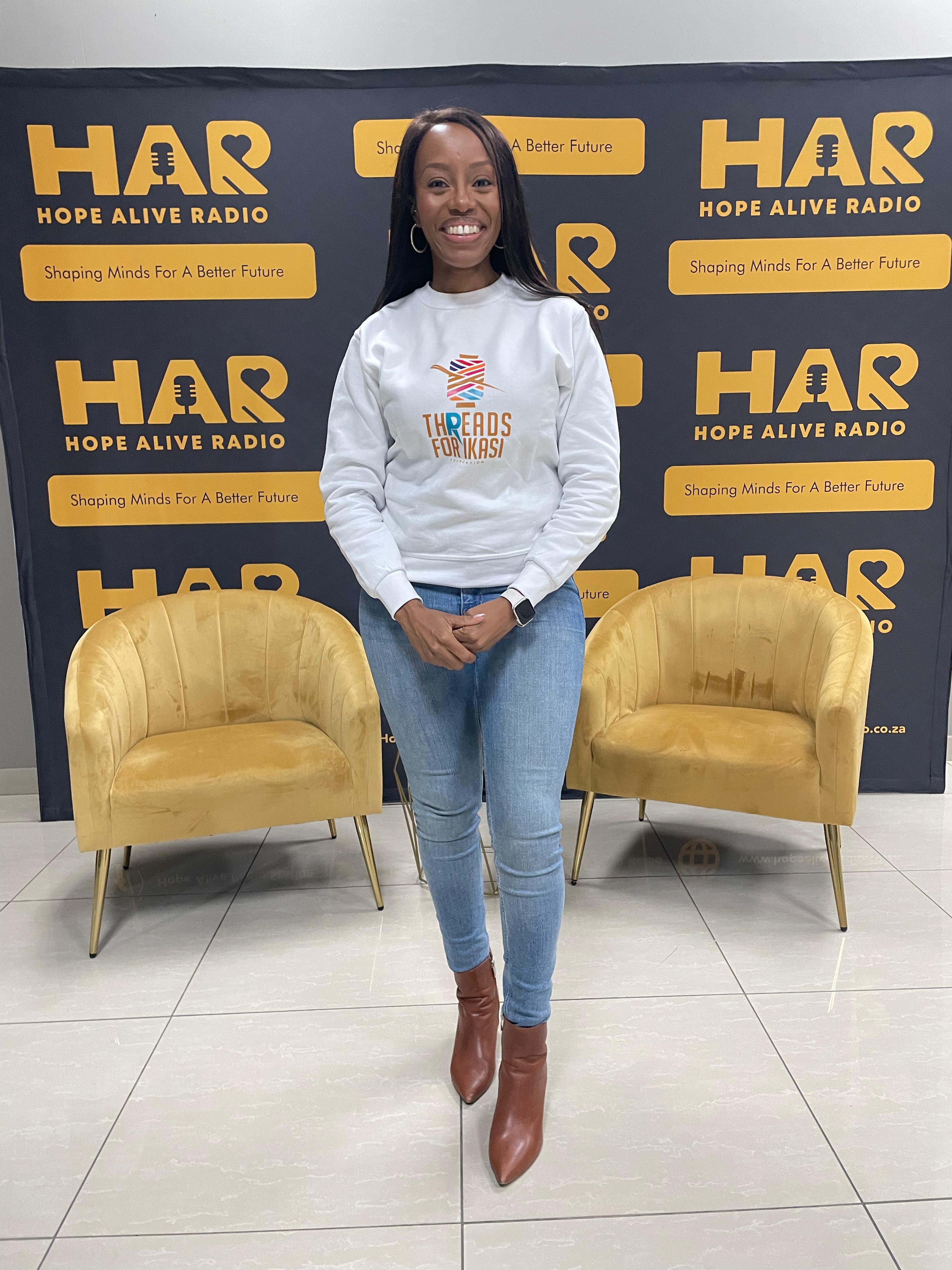 Khabo Mnguni at Hope Alive Radio studio on 18 June 2026, wearing a Threads for iKasi Foundation sweatshirt